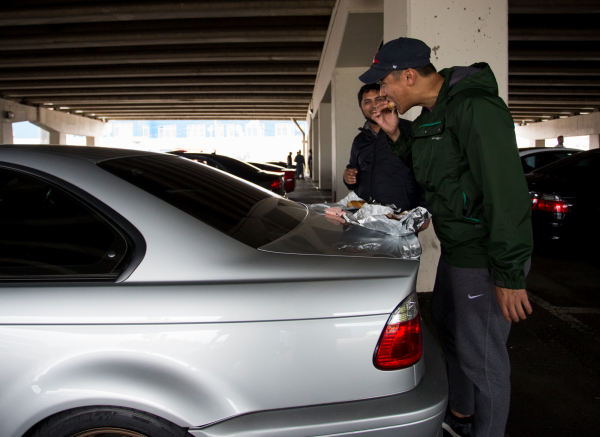 Yasser Ameen, left, and Aaron Han elected to use Han's E46 M3 trunklid for a table since seating across the street was limited.