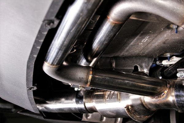 The pipes routed off of the exhaust and wrapped in the bumper act as Helmholtz resonators