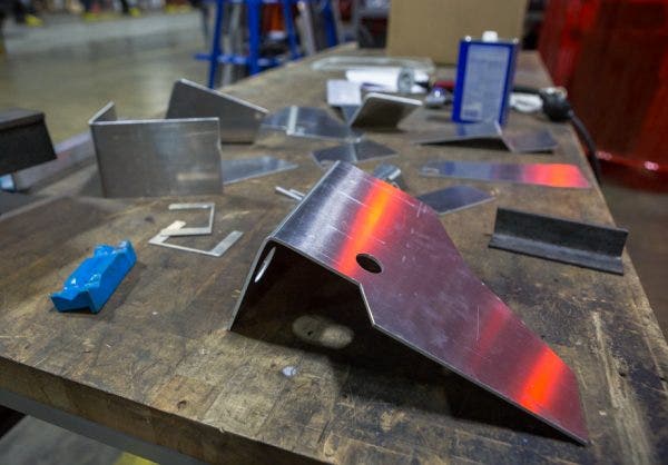 After the sections are cut, Mike uses a hydraulic press to form each piece into its specific shape.