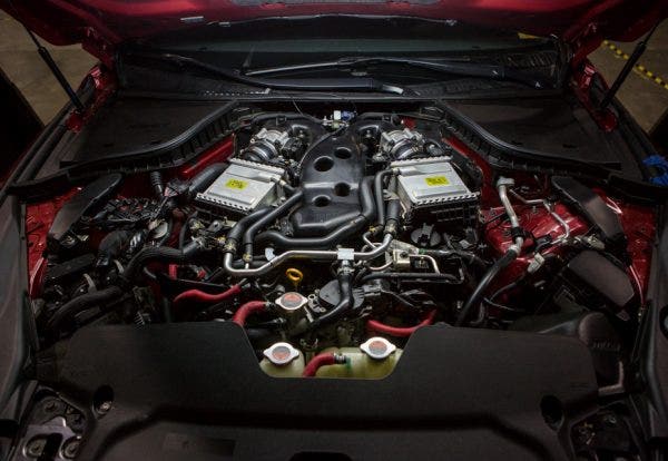 After the engine cover comes off, our task looks even more daunting. The decorative panel mostly just shrouds the organized chaos that lurks underneath.