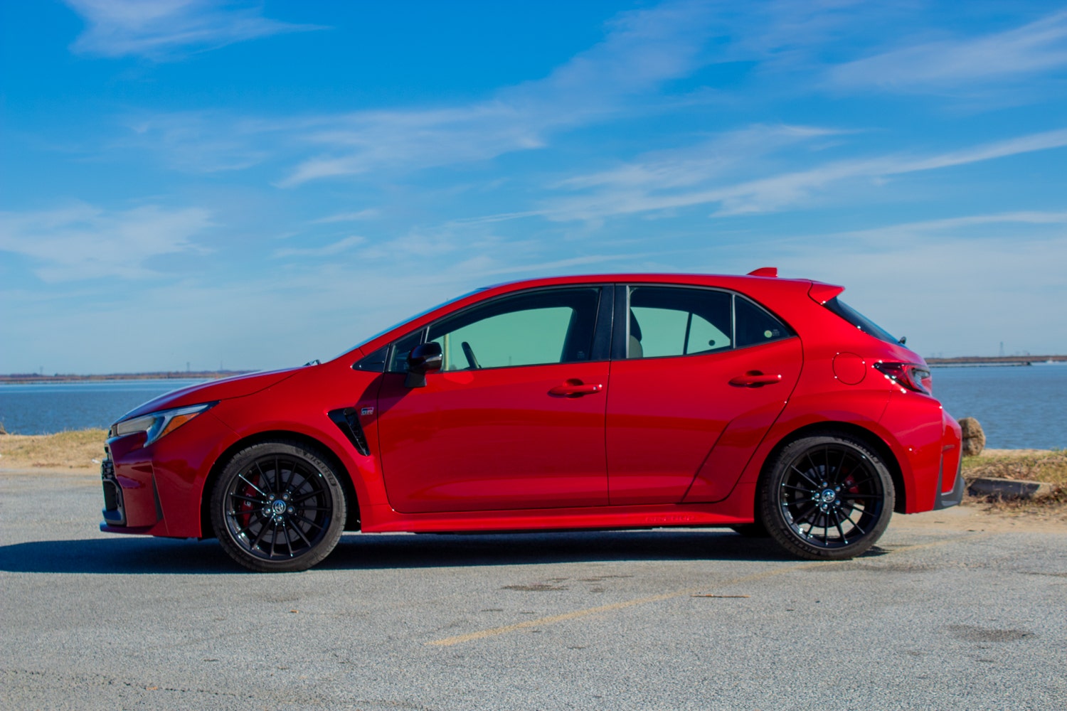 A 2023 Toyota GR Corolla next to a body of water.