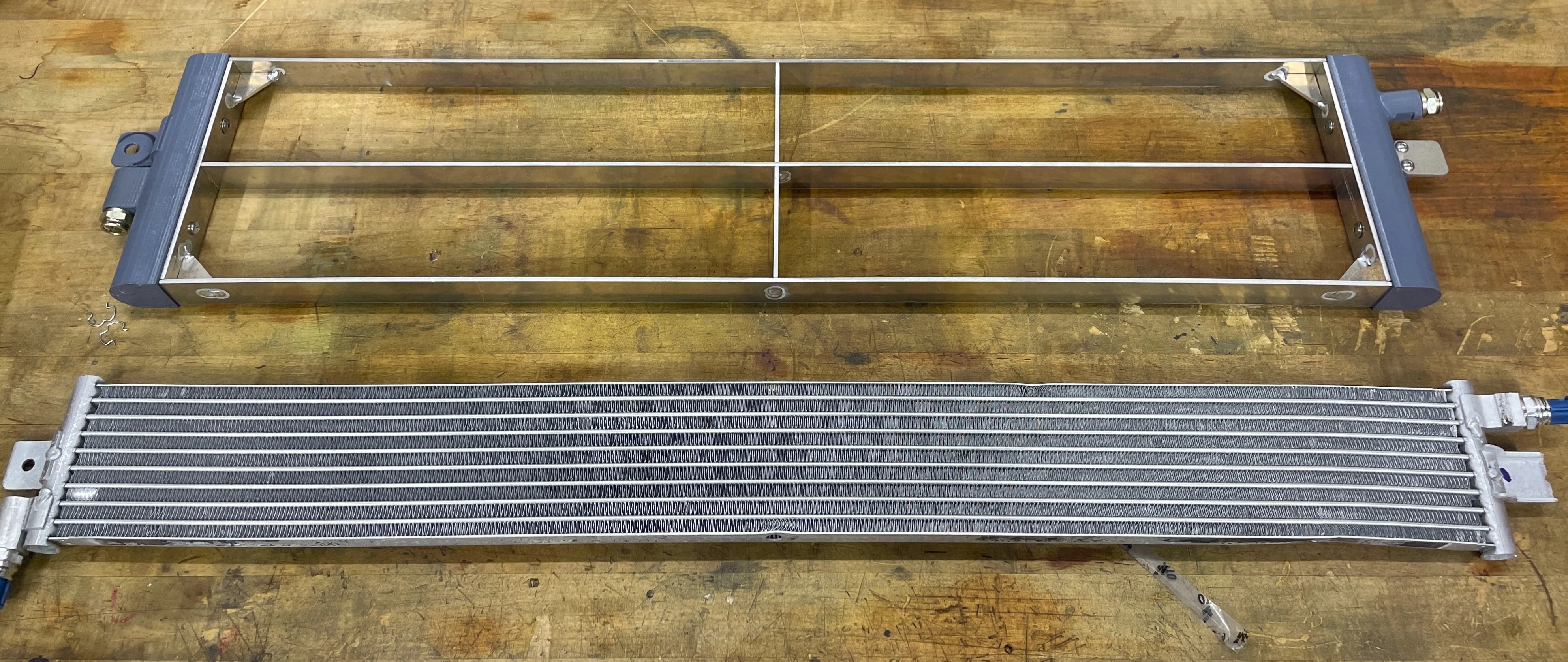 The stock transmission cooler next to a test-fitment Mishimoto prototype. The stock transmission cooler next to a test-fitment Mishimoto prototype.