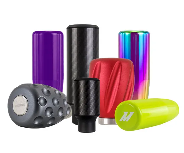 An image of several differently colored Mishimoto shift knobs.