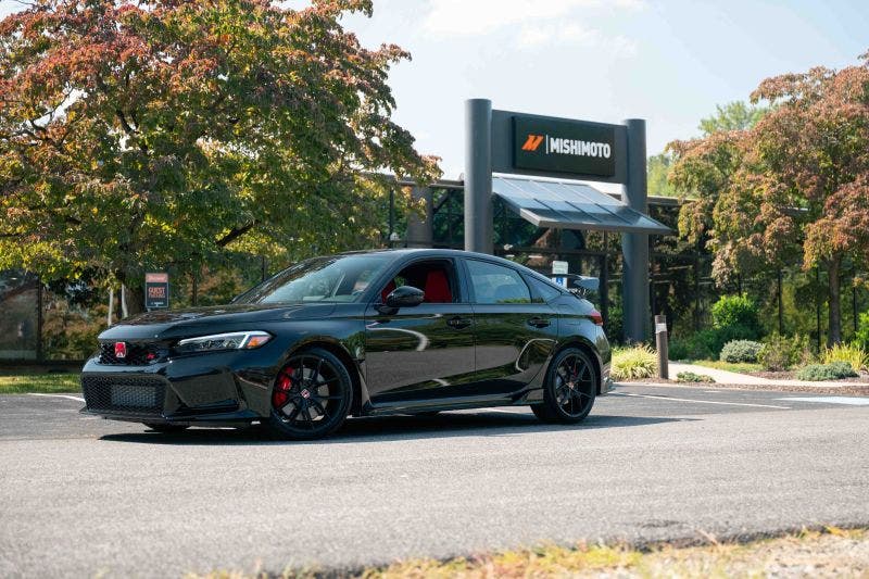 An image of a black Honda Civic Type-R FL8 parked in front of the new Mishimoto headquarters.