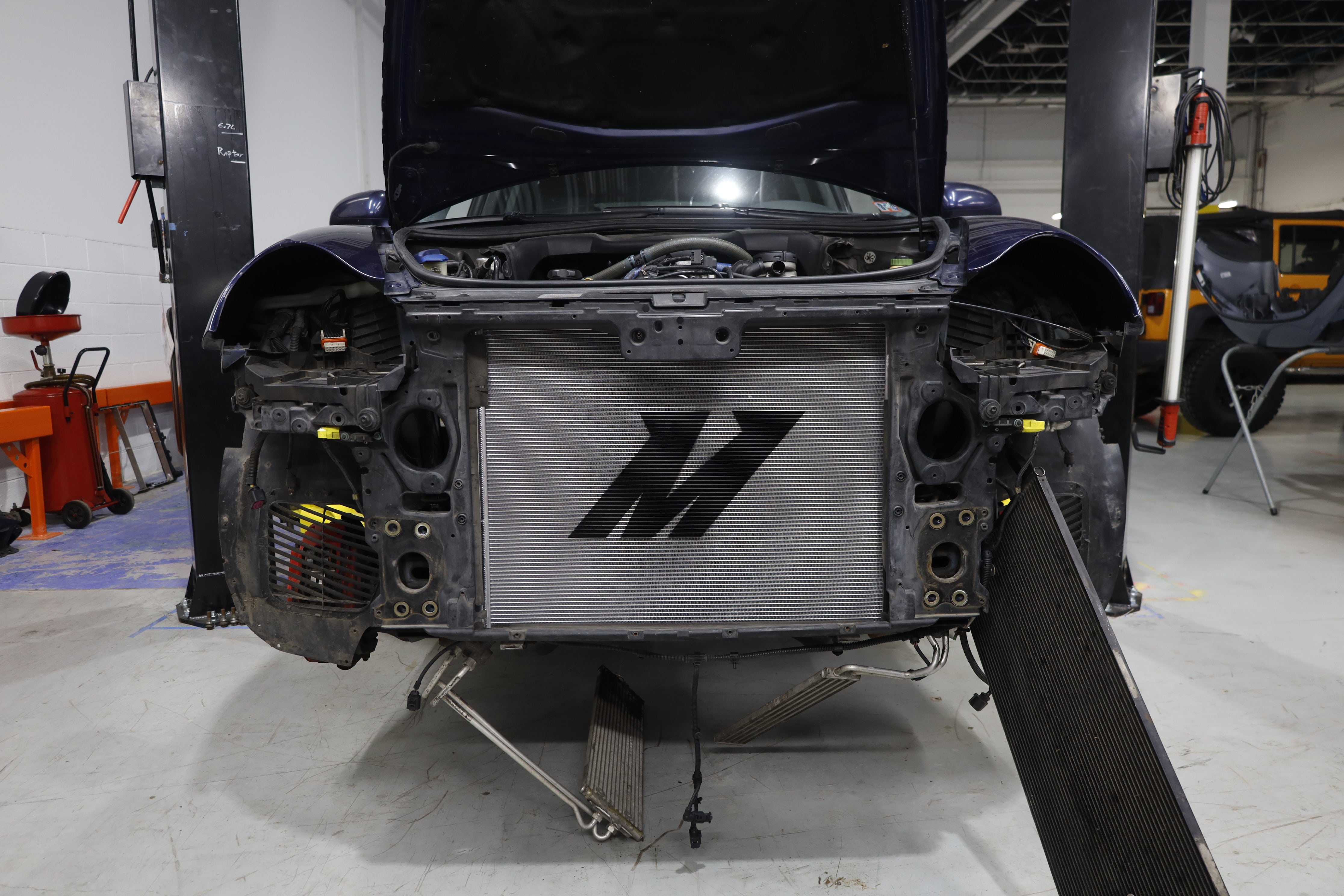 An image of the Mishimoto Performance Aluminum Radiator installed on a Porsche Cayenne with the front grill removed.