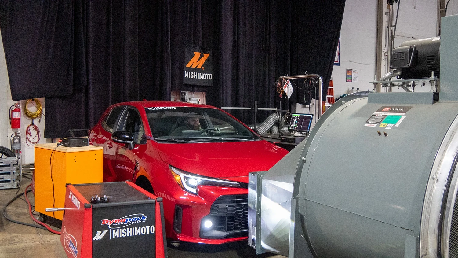 An image of our red 2023 Toyota GR Corolla mounted to our dyno for performance testing.