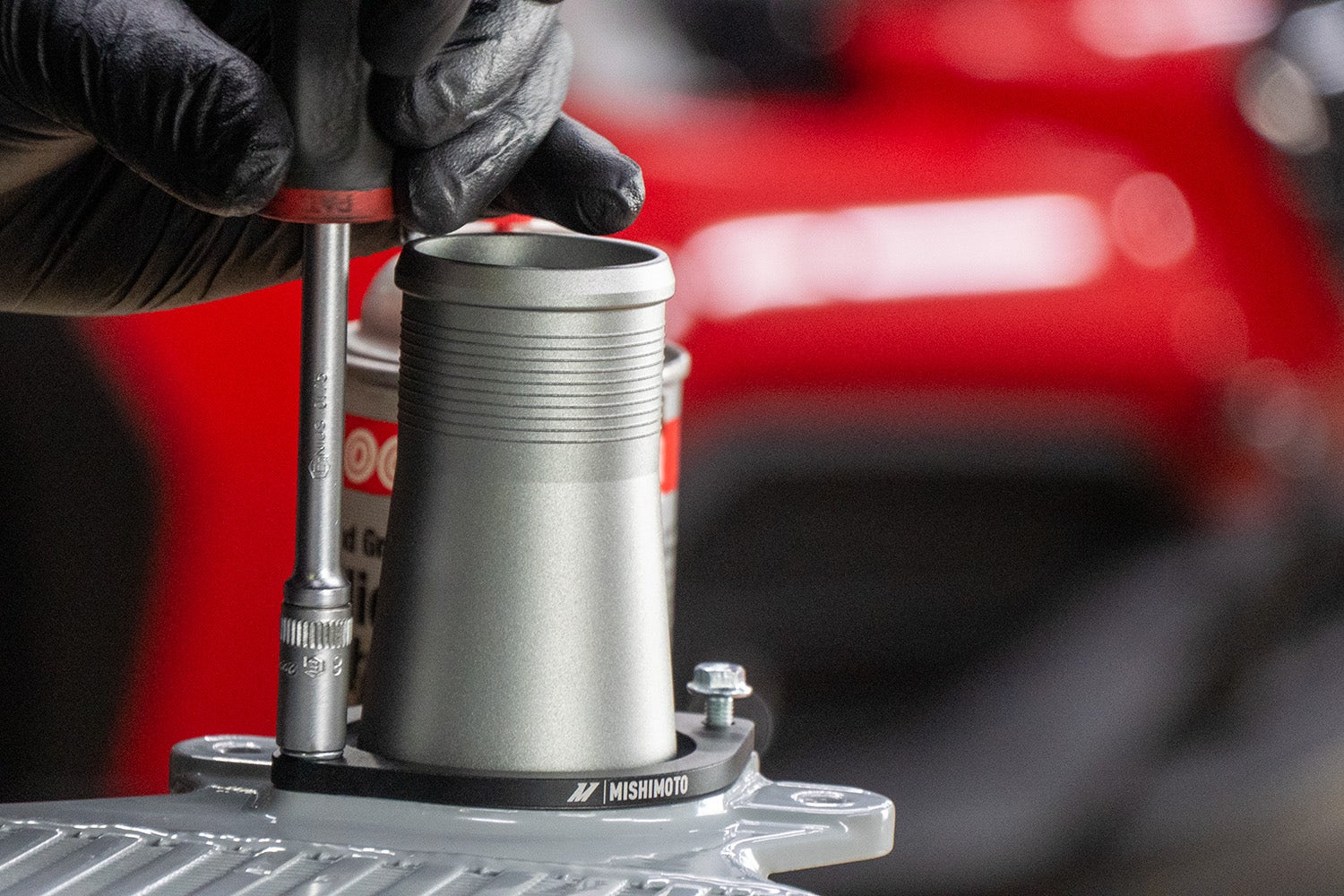 An image of our engineer attaching piping to the Mishimoto intercooler.